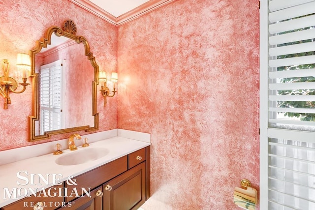 bathroom featuring crown molding and vanity