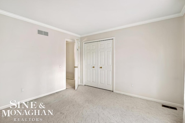 unfurnished bedroom with light colored carpet, a closet, and ornamental molding