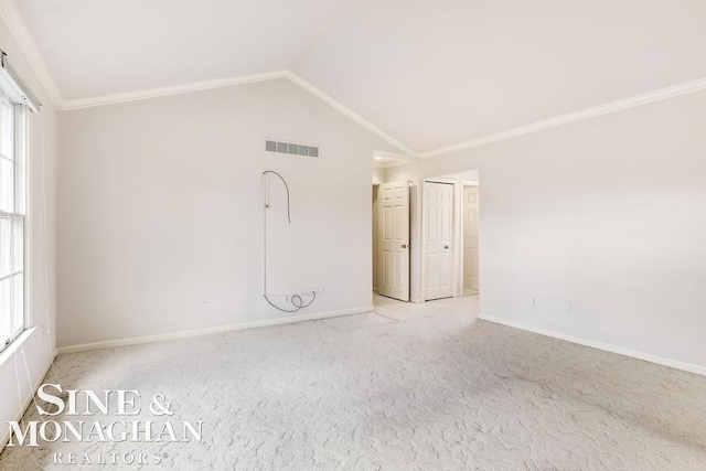 carpeted spare room featuring lofted ceiling and ornamental molding