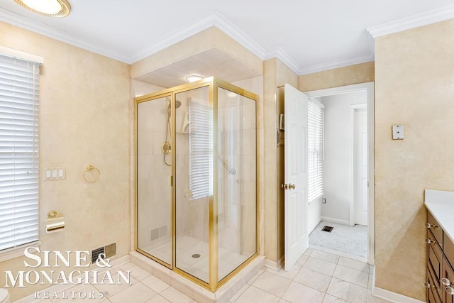 bathroom featuring vanity, an enclosed shower, ornamental molding, and tile patterned flooring