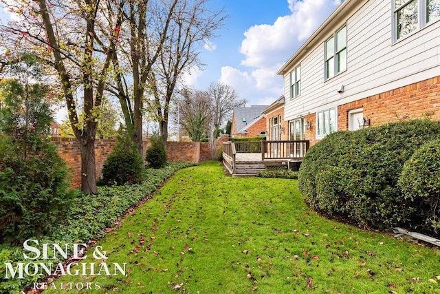 view of yard featuring a wooden deck and central AC unit