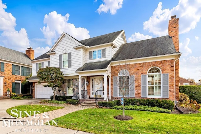 view of property featuring a front lawn and a garage