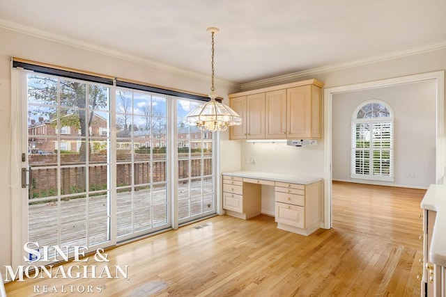 kitchen featuring built in desk, light hardwood / wood-style floors, and a wealth of natural light