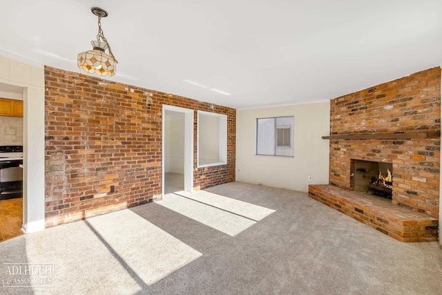 unfurnished living room with light colored carpet, brick wall, and a brick fireplace