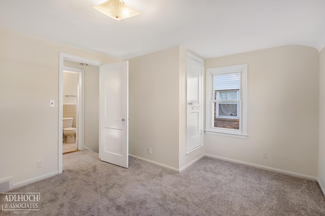 unfurnished bedroom with light colored carpet