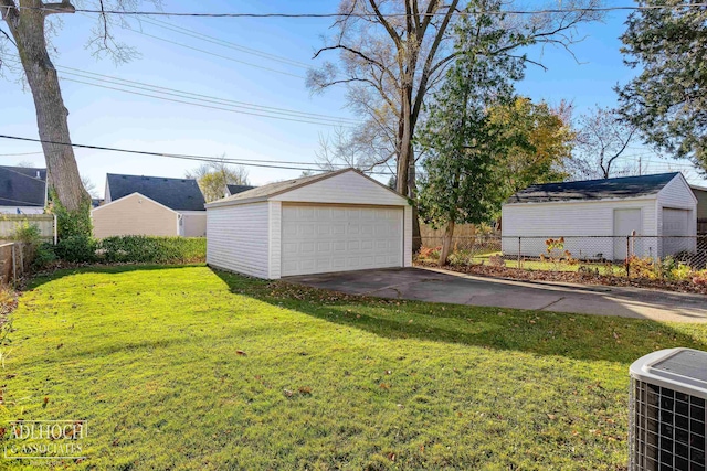 view of yard featuring a garage, central AC unit, and an outdoor structure