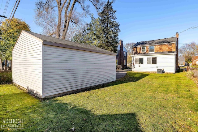 exterior space featuring a lawn and central air condition unit