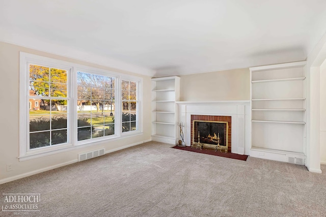 unfurnished living room with a fireplace and carpet floors