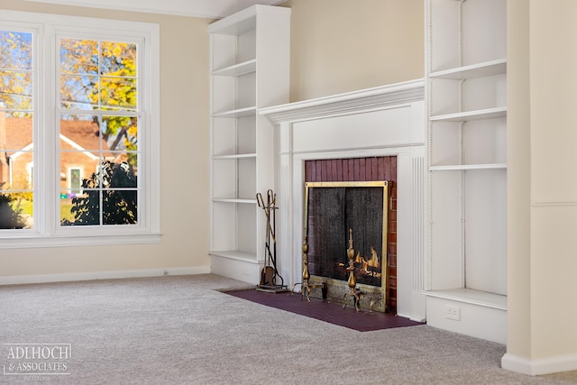 unfurnished living room with a brick fireplace and carpet