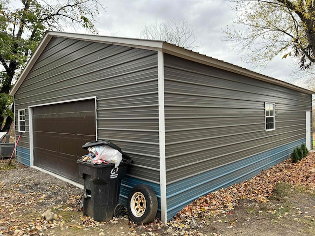 view of property exterior featuring a garage and an outdoor structure