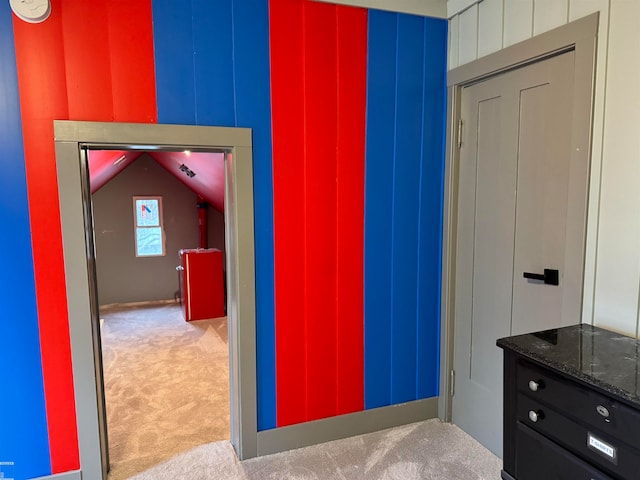 unfurnished bedroom featuring carpet and lofted ceiling