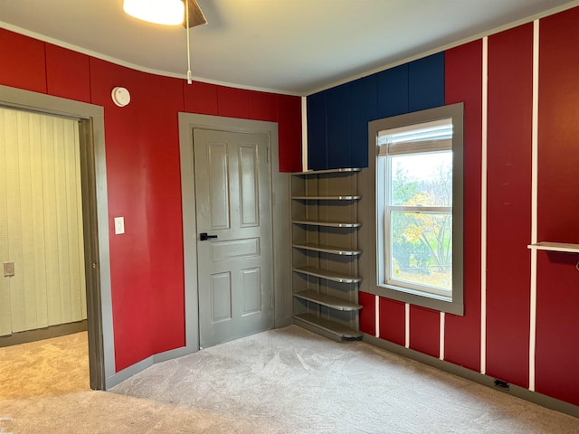 interior space with ceiling fan and light colored carpet