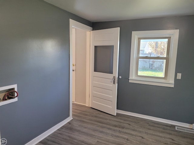 interior space with dark hardwood / wood-style flooring and hookup for a washing machine