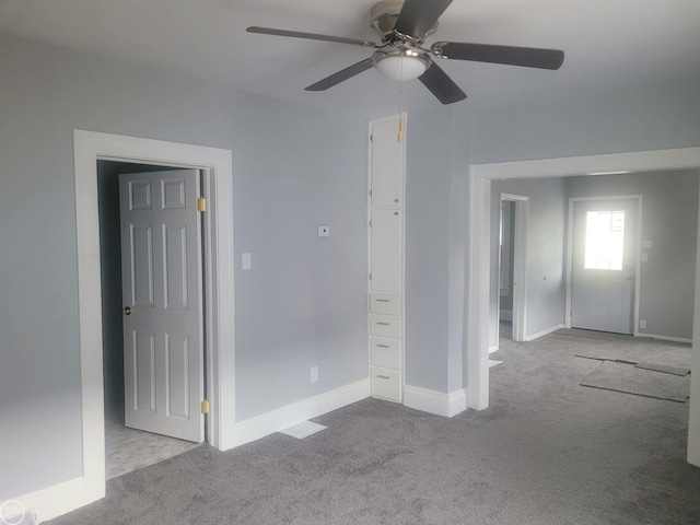 carpeted empty room featuring ceiling fan