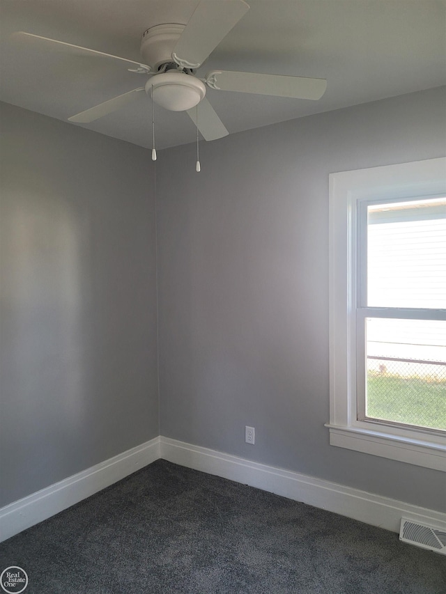 carpeted spare room with ceiling fan