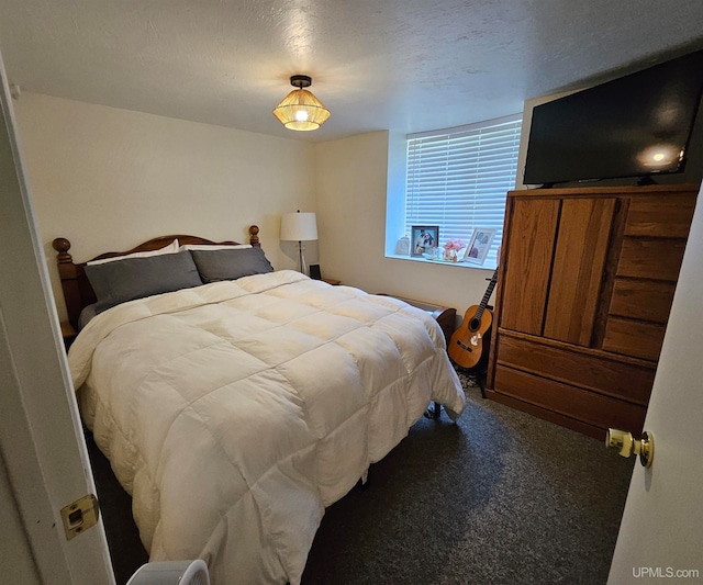 carpeted bedroom with a textured ceiling