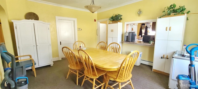 dining area featuring crown molding, a baseboard radiator, and dark carpet