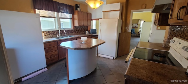 kitchen featuring a center island, white fridge, exhaust hood, and sink