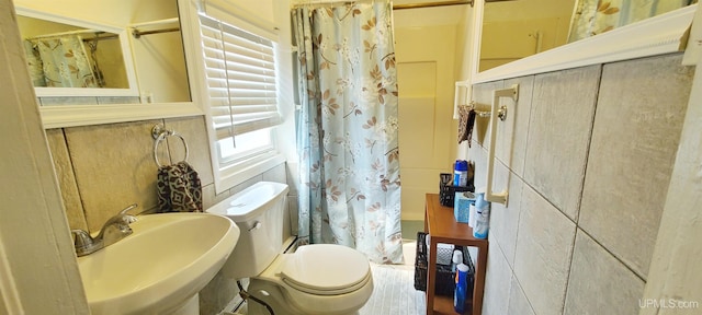 full bathroom with toilet, sink, and shower / tub combo with curtain