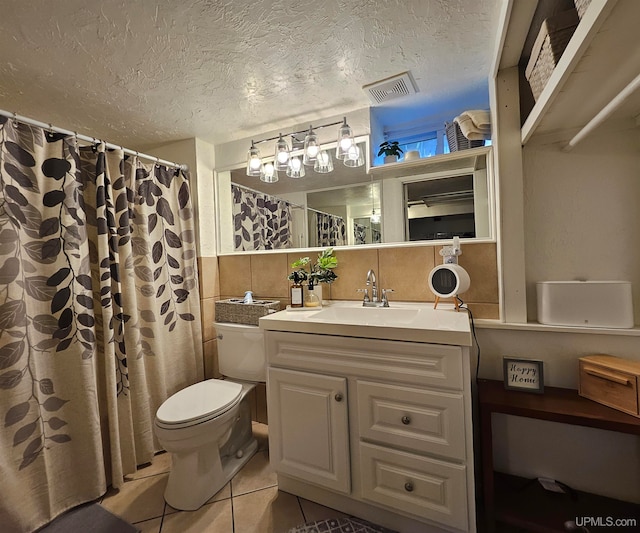 bathroom with vanity, backsplash, tile patterned floors, toilet, and a textured ceiling