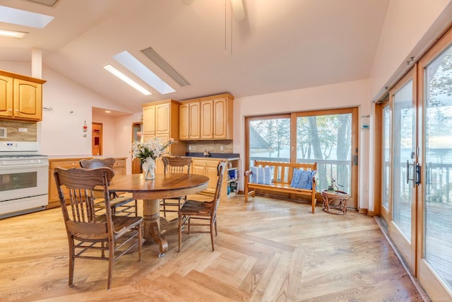 dining room with lofted ceiling with skylight