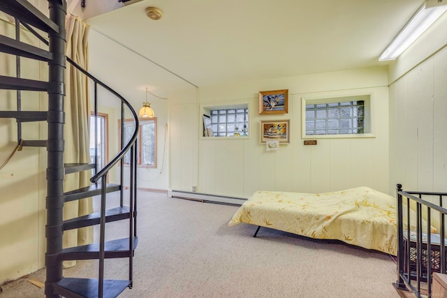 carpeted bedroom with a baseboard heating unit and multiple windows