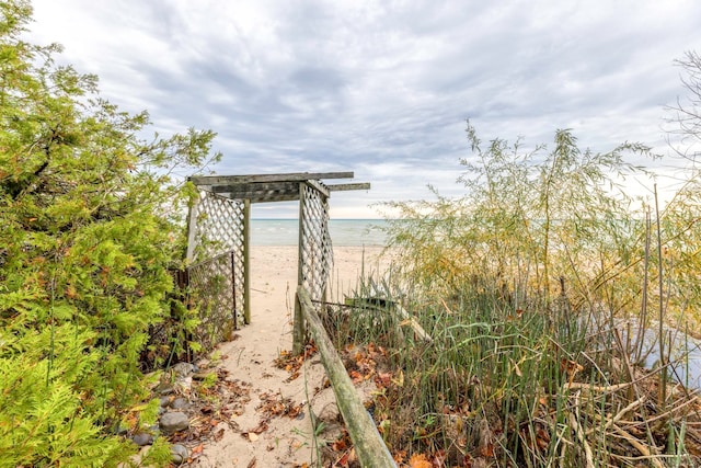 exterior space featuring a water view and a beach view