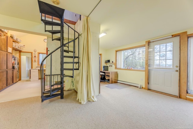 basement with light colored carpet and a baseboard heating unit