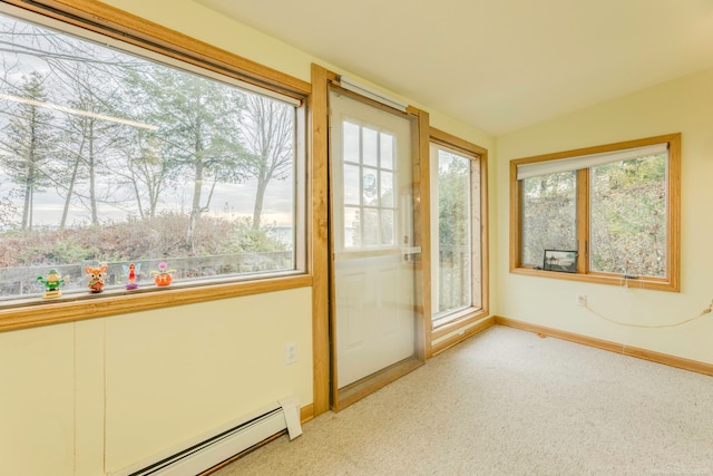 unfurnished sunroom with a baseboard heating unit