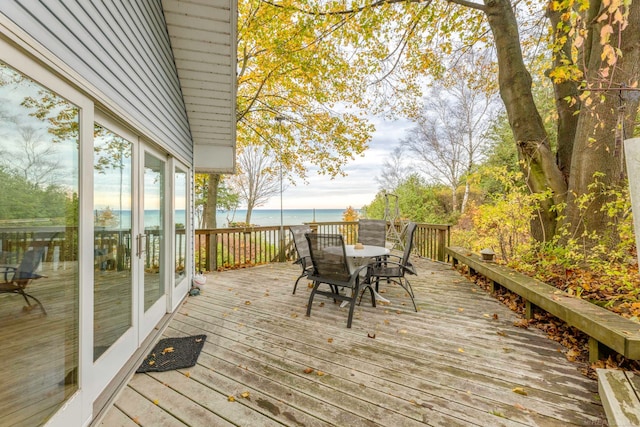 wooden deck featuring a water view and a beach view