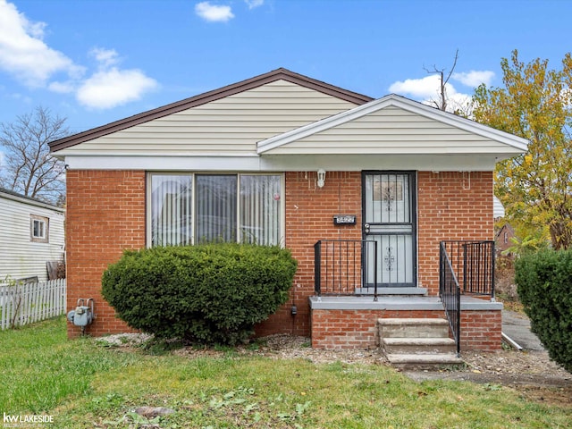 bungalow-style house featuring a front yard