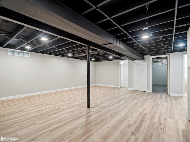 basement featuring light hardwood / wood-style floors