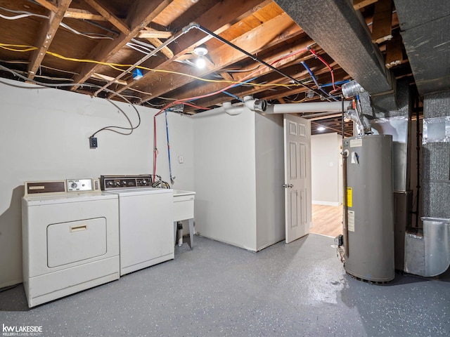 basement with washing machine and dryer and water heater