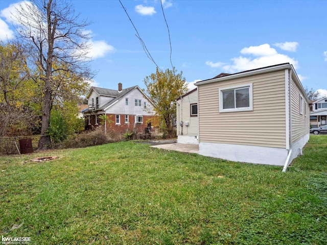 back of house featuring a yard