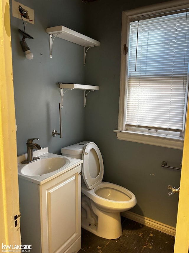 bathroom featuring vanity and toilet