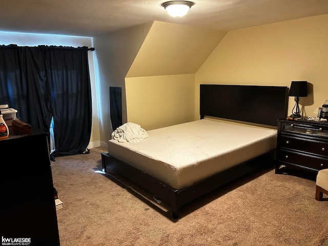 carpeted bedroom featuring lofted ceiling