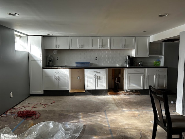 kitchen featuring tasteful backsplash and white cabinets