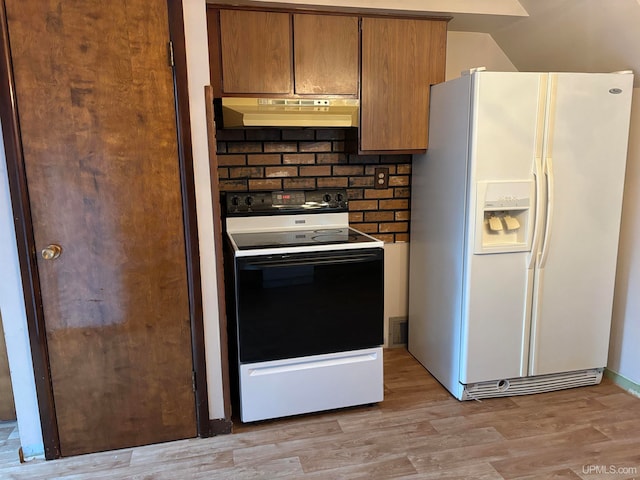 kitchen featuring backsplash, white appliances, and light wood-type flooring