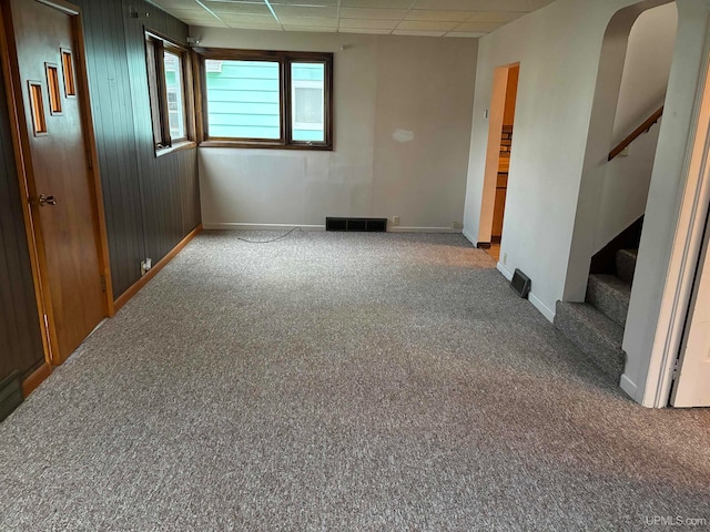 carpeted spare room with a paneled ceiling