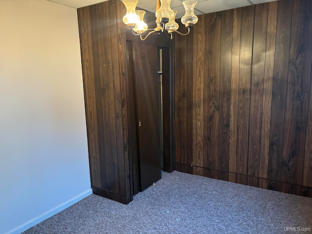 interior space with wooden walls and an inviting chandelier