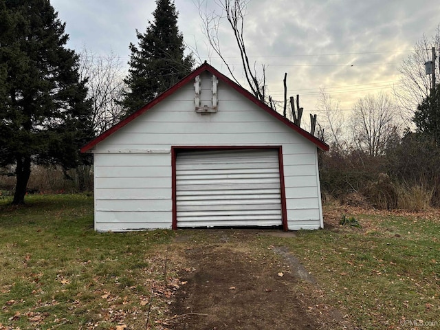 garage featuring a lawn