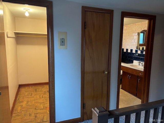 bedroom featuring sink and light parquet floors