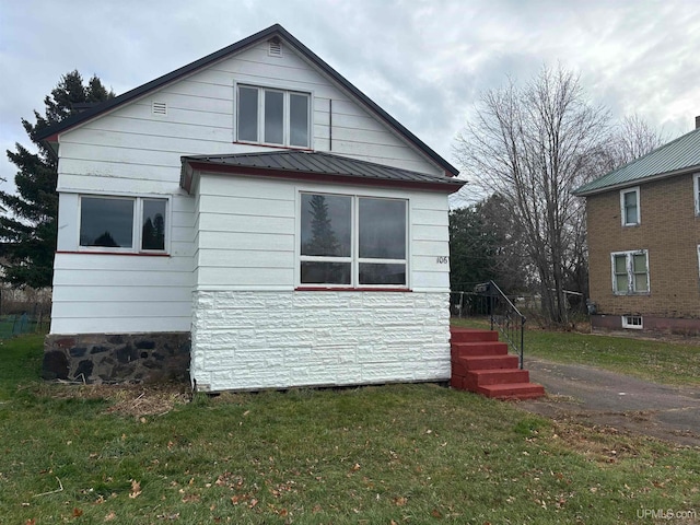 view of side of home featuring a yard