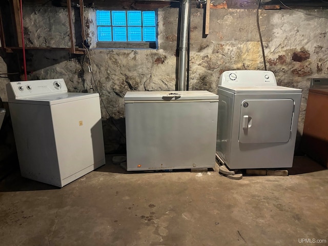 clothes washing area with separate washer and dryer