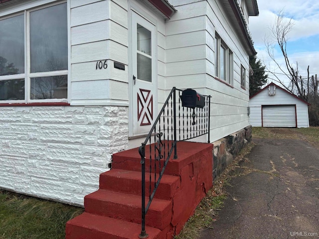 view of side of home with a garage and an outdoor structure