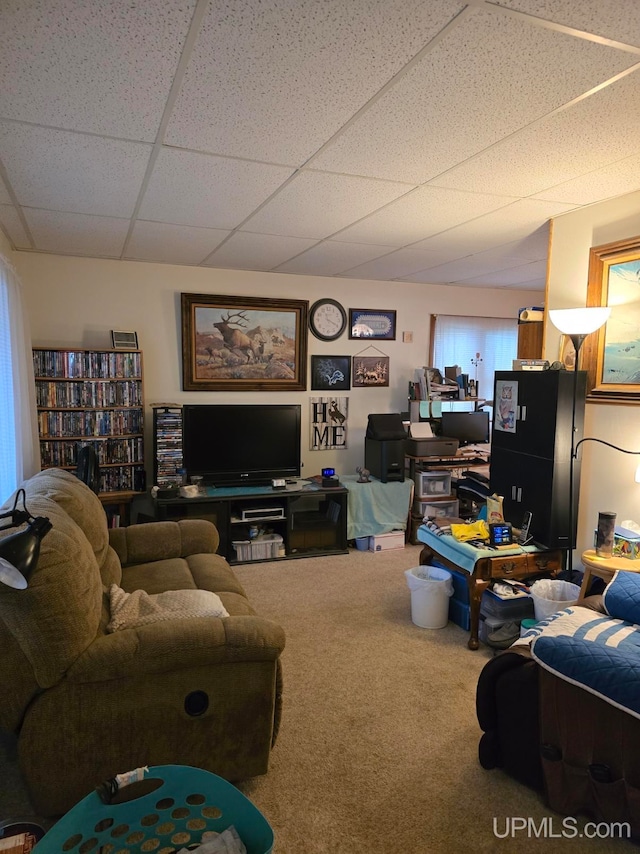 carpeted living room with a drop ceiling