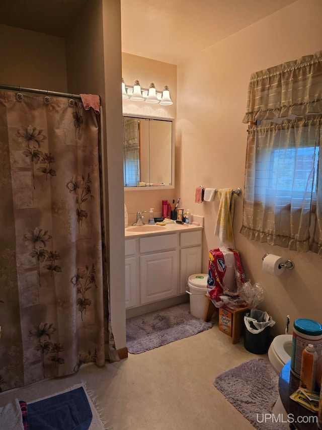 bathroom with vanity, toilet, and walk in shower