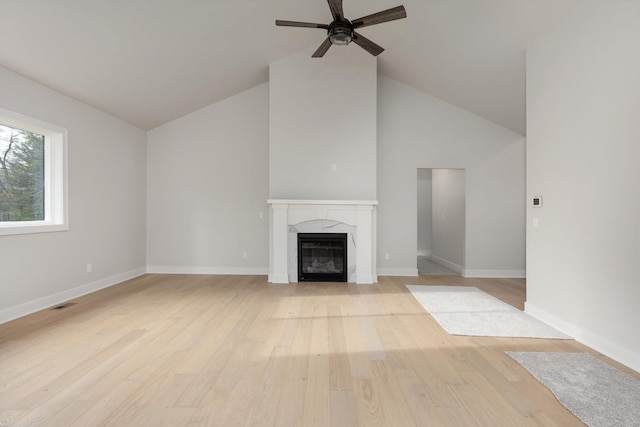 unfurnished living room featuring ceiling fan, high vaulted ceiling, and light hardwood / wood-style floors