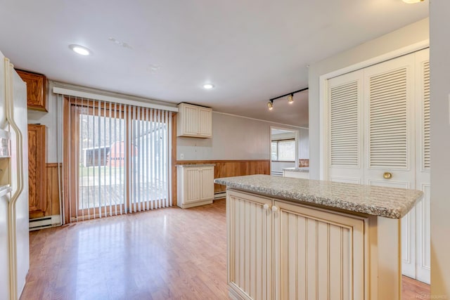 kitchen featuring a center island, light hardwood / wood-style floors, rail lighting, and a baseboard radiator