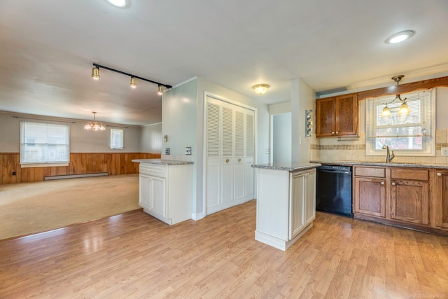 kitchen with dishwasher, a center island, light hardwood / wood-style flooring, a baseboard heating unit, and wooden walls